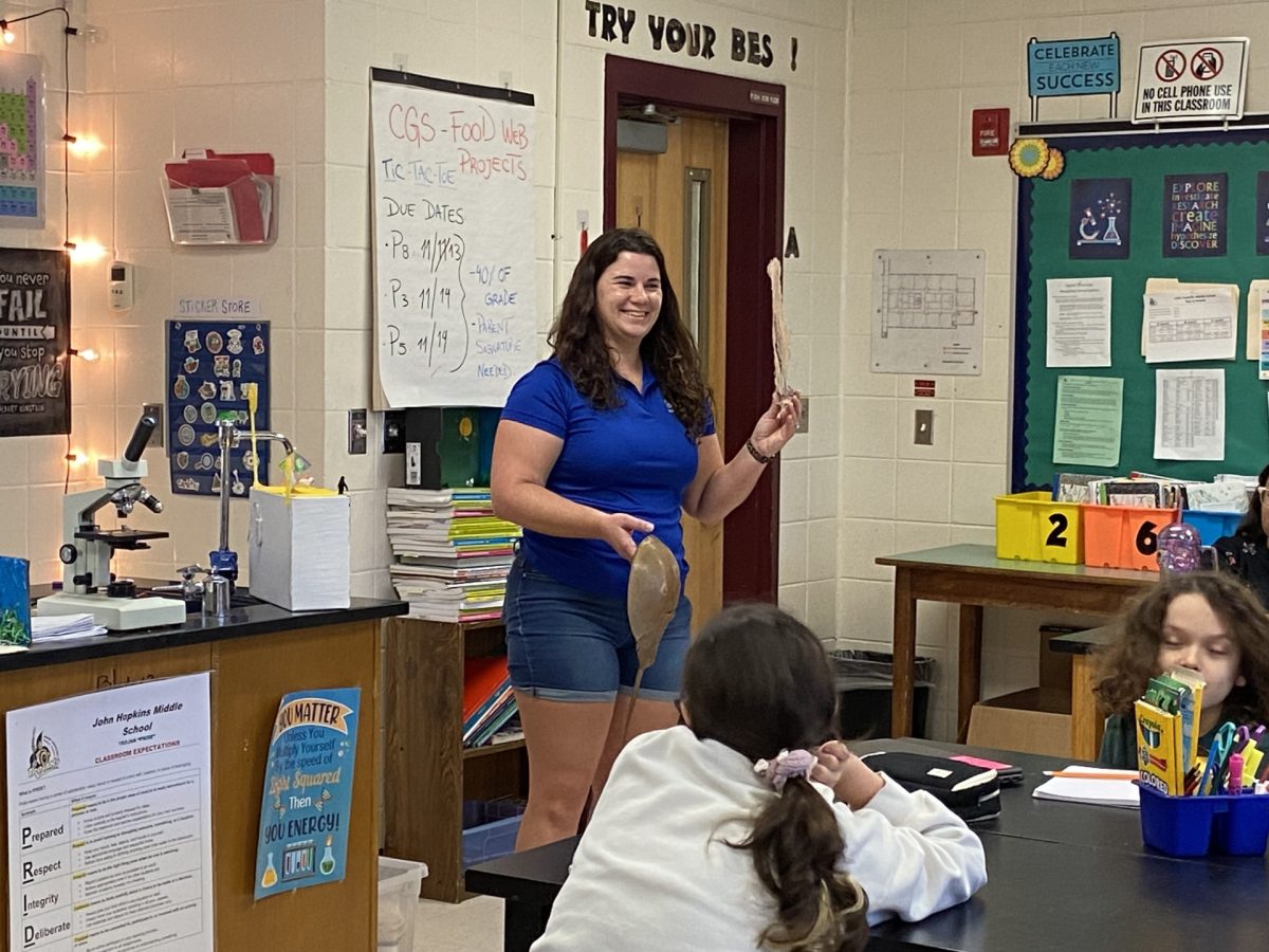 Biologist Makenzie Kerr’s talks with a science class.