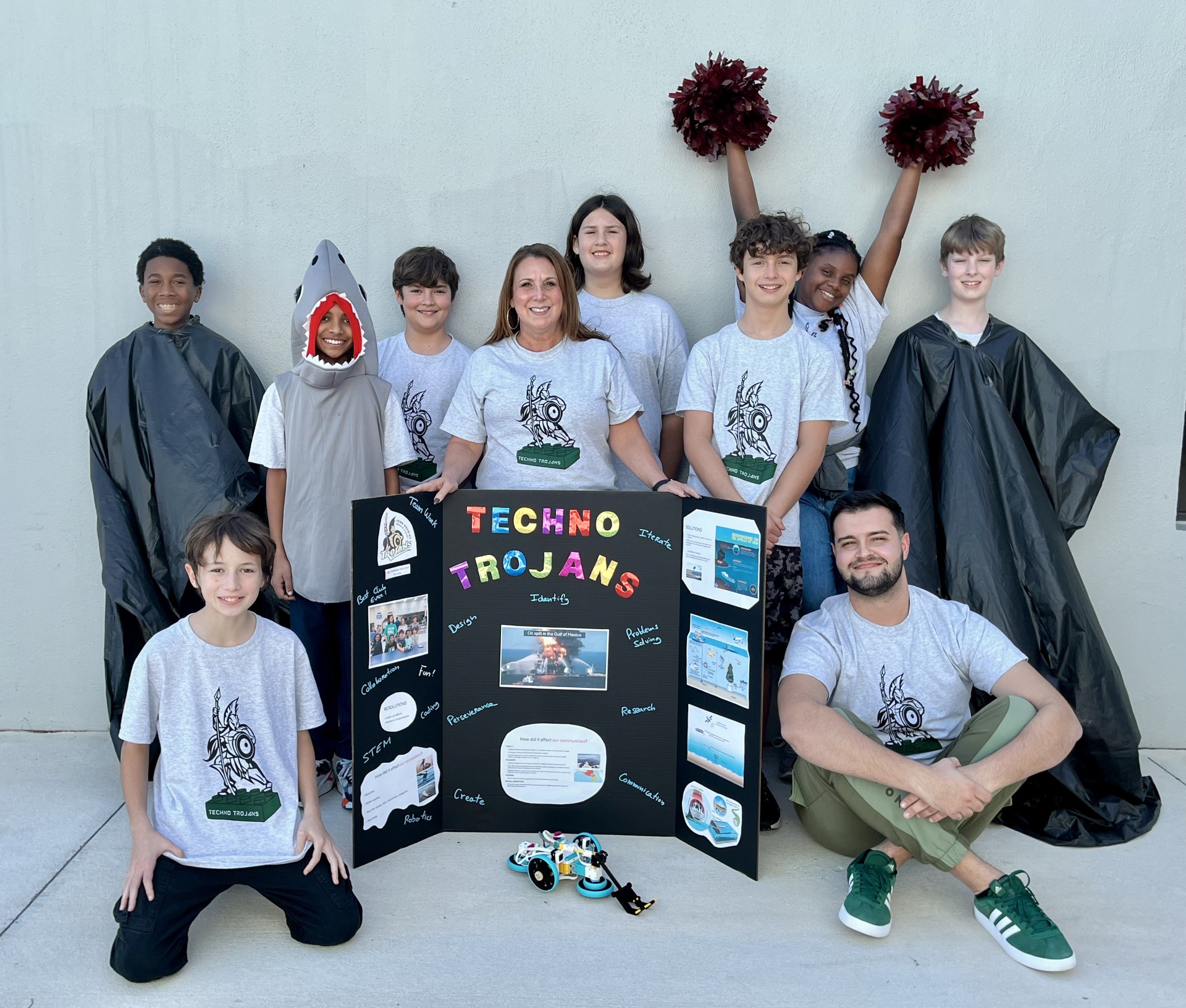 In front are Axel Vaurie and teacher Ivo Decarlis. In back are David Benson, Steven Samuel, Matteo Romig , teacher Donna East, Charles Dreger, Nick Romig, Riley Gallow-Braxton, and Eli Fischer.