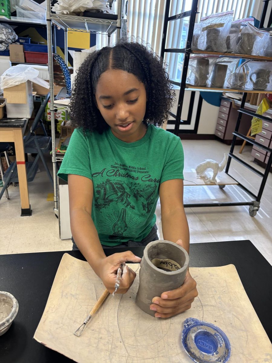 Seventh-grader Gabby Barron molds her sculpture made from clay and a soda can in Ms. Black's class. 