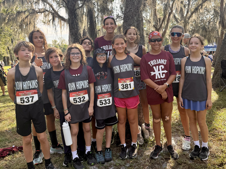 The 2025 JHop cross-country team with Coach Kylie Mathews at the PCAC Cross Country Championship in Largo.