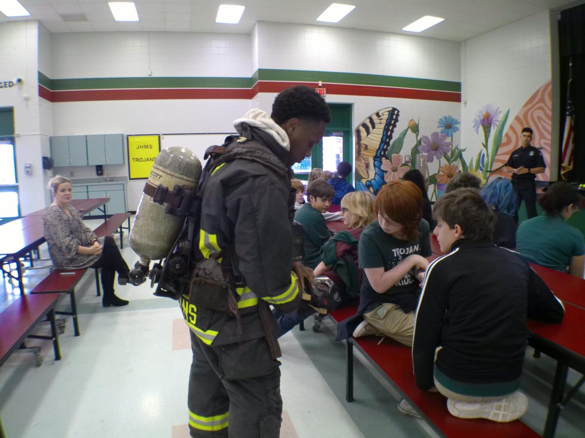 A St. Petersburg Fire Department firefighter demonstrates how his suit works to JHop scholars during the Great American Teach-In. 
