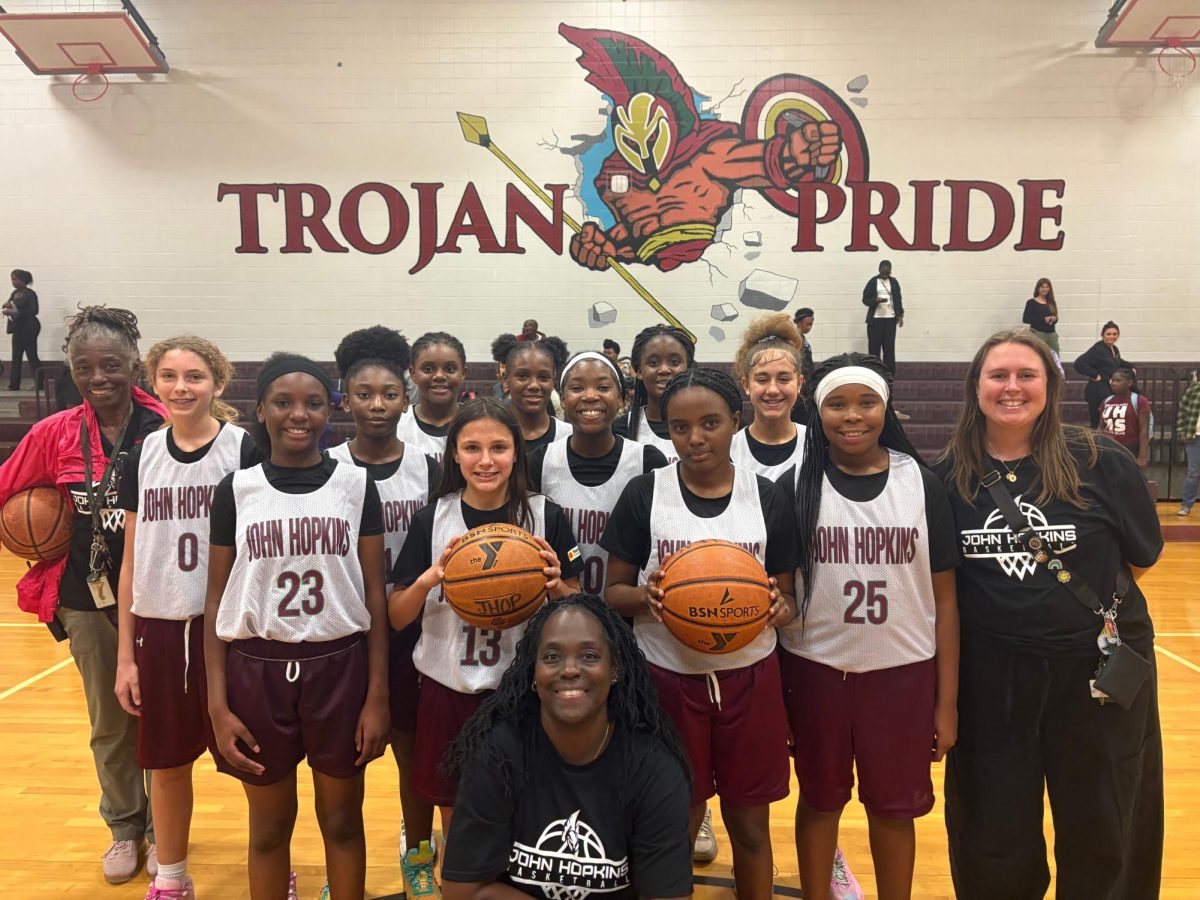 The John Hopkins Middle School girls basketball team with Coach Hall, Coach Caldwell and Coach Forte.
