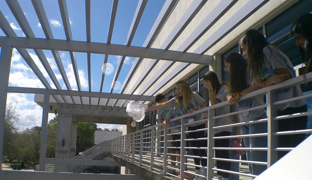 Students from East Lake Middle School drop a makeshift parachute from a balcony at University of South Florida St. Petersburg.