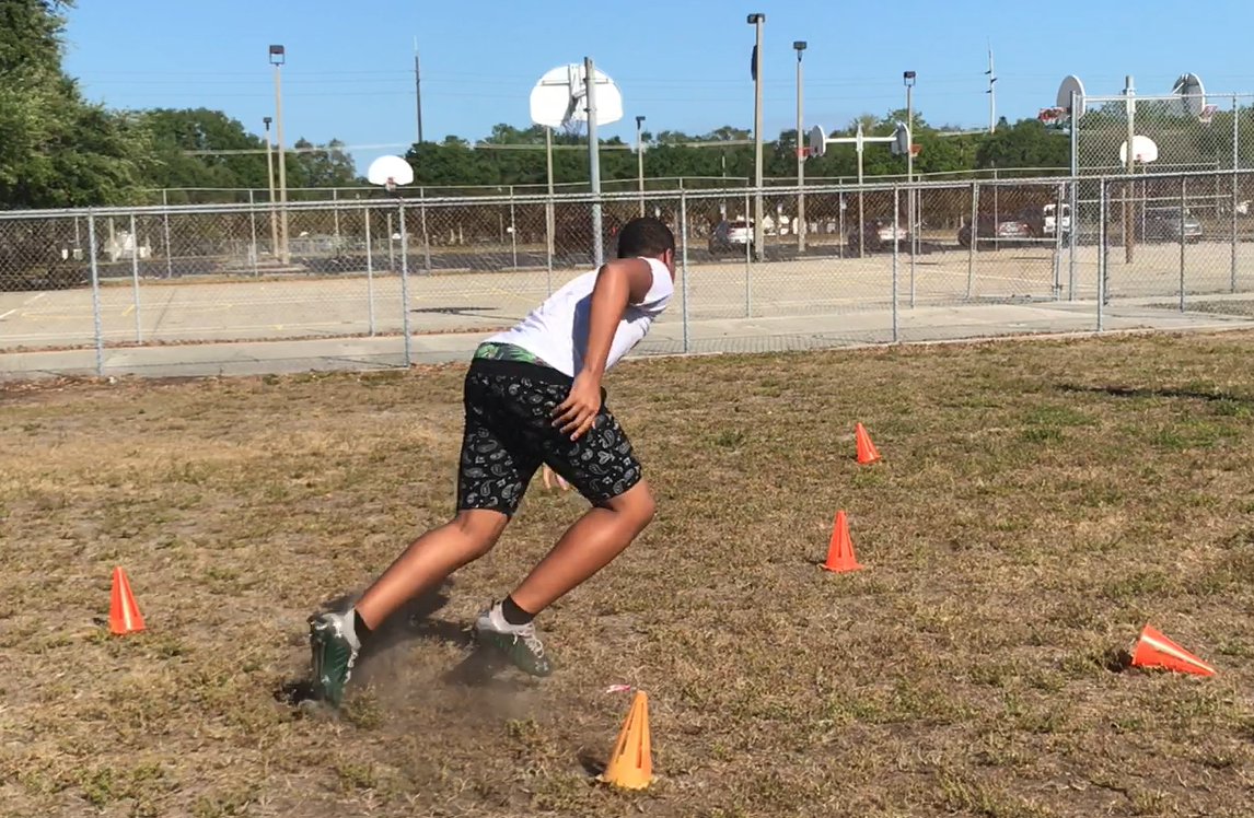 A JHop flag football player performs an agility drill.