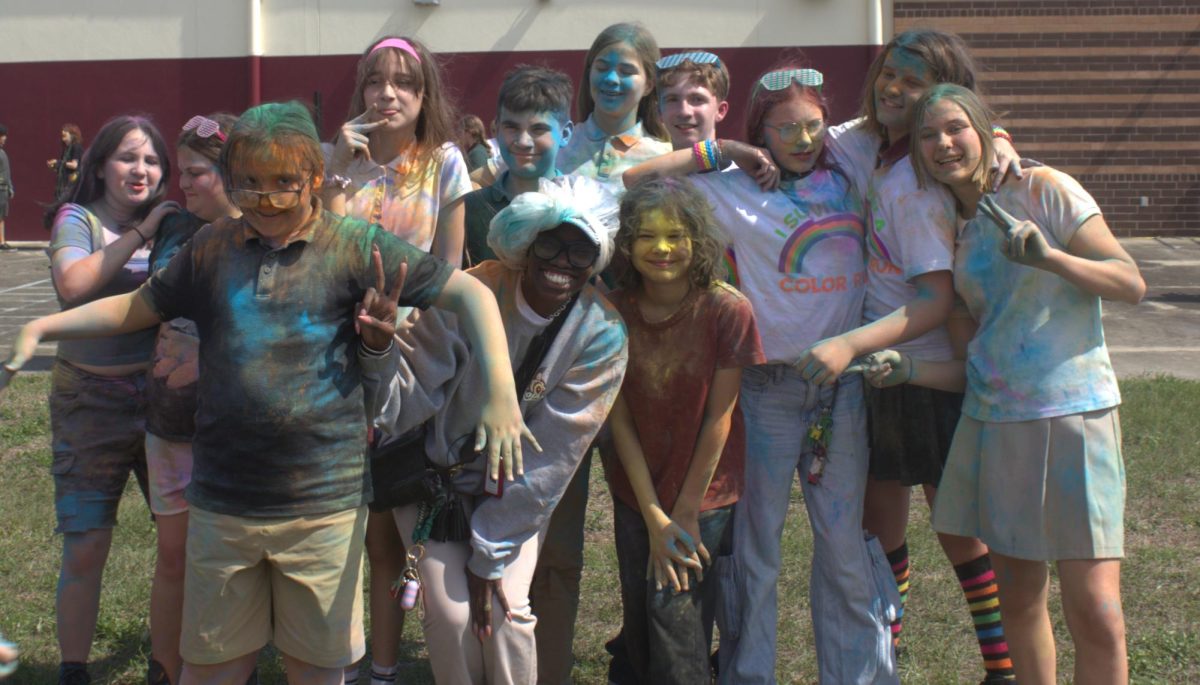 Principal Brittnee Scott poses with scholars during the Color Run.