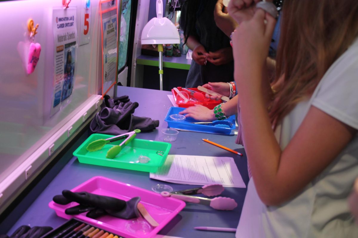 Scholars work together at one of the Innovation Bus' stations.